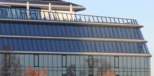 A large building with a lot of windows on top of it